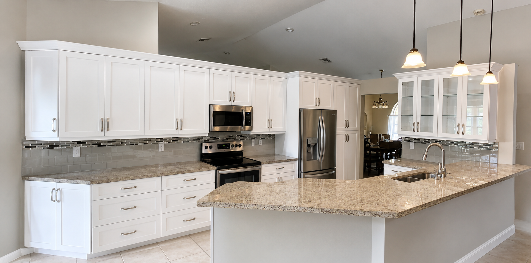 White Shaker kitchen with glass display uppers, tile backsplash, and a large granite peninsula