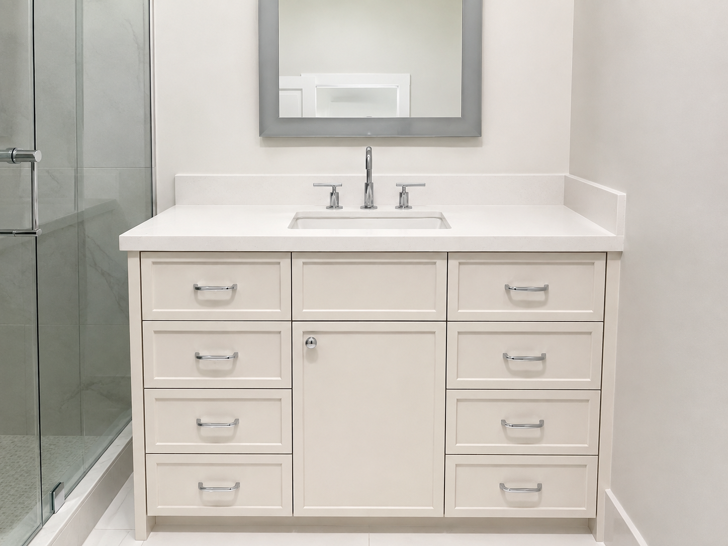 White single vanity with a center cabinet and drawer stacks beneath a solid white countertop