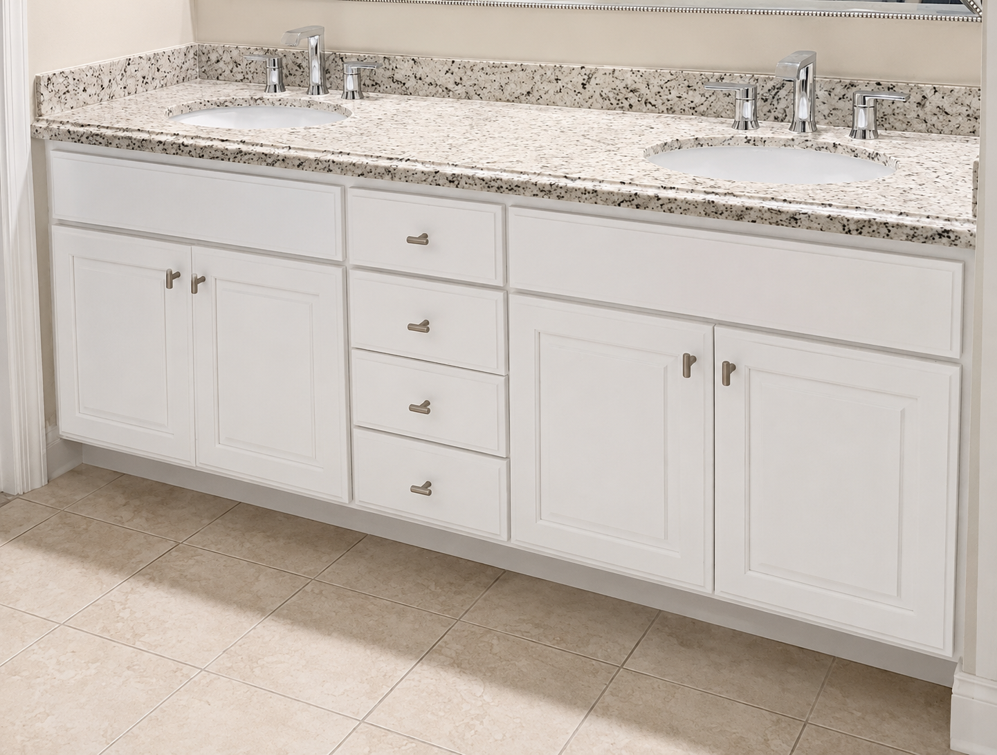 Wide white double vanity with raised-panel doors, drawers, and a speckled stone countertop